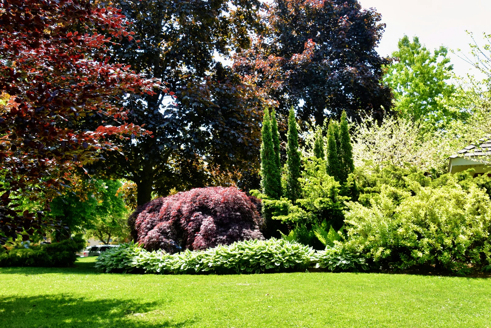 Beautiful landscaped property with maintained lawn and garden
